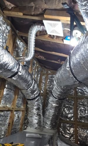 Ductwork In Insulated Attic With Ventilation Fan And Light